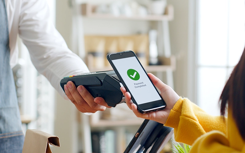 person paying with their phone